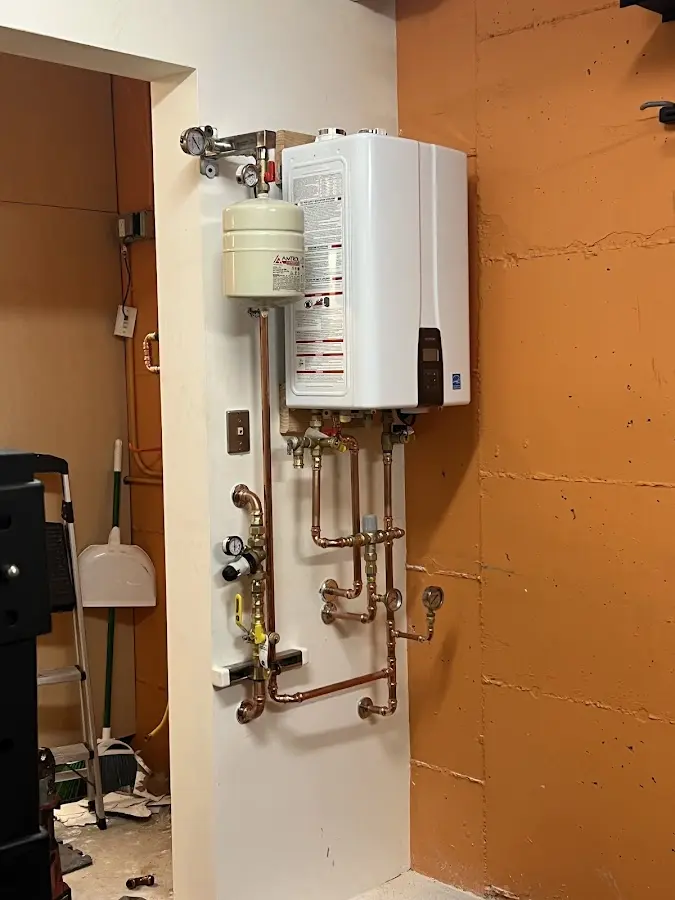 Plumbing technician inspecting water heater connections in Rolling Meadows
